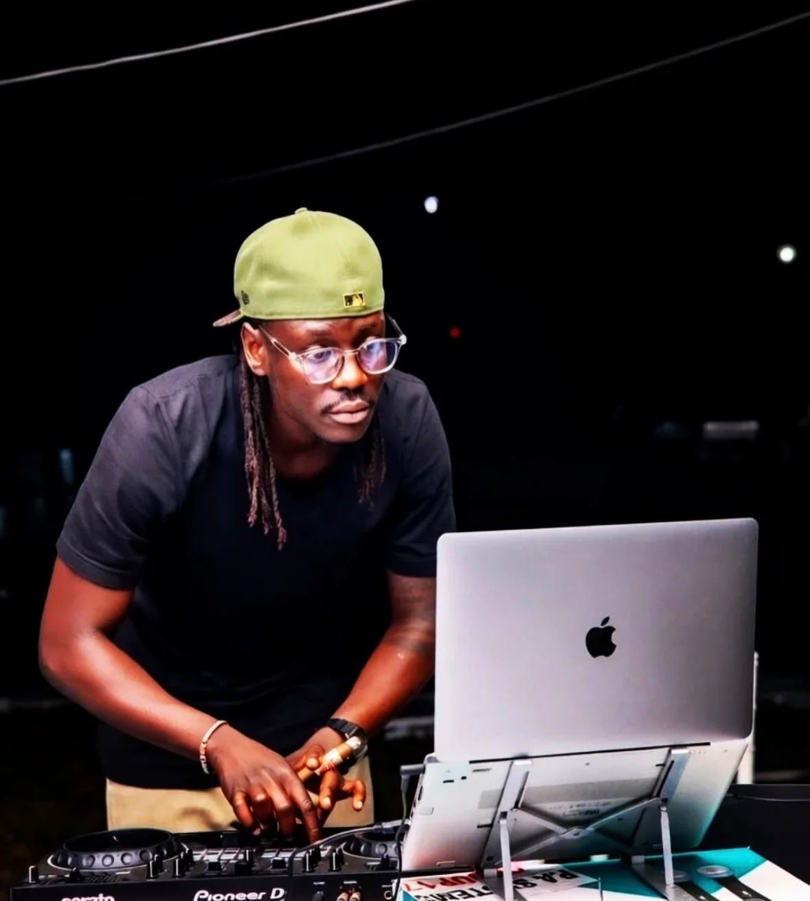 DJ BMT working the Pioneer mixer at night